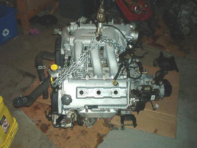 1994 Mazda MX-3 - This engine is suspended by chains, ready for installation or removal.