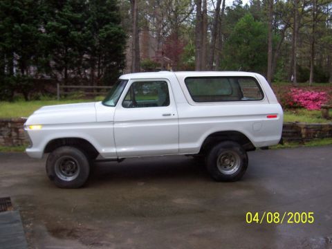 1979 Ford Bronco - This 1978 Ford Bronco is shown from the side, parked outdoors on a wet surface.