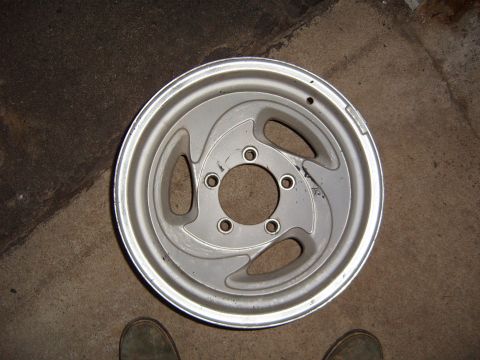 1993 Ford Bronco - A single aluminum wheel is shown lying on a concrete surface.