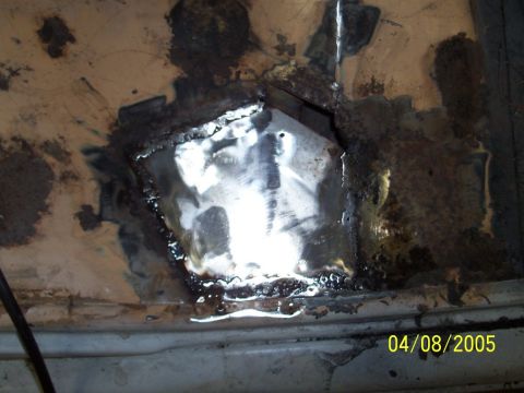 1979 Ford Bronco - Metal panel shows significant rust and has been repaired with a welded patch.