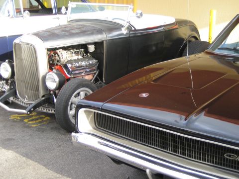 1968 Ford Mustang - Two classic cars, a hot rod and a muscle car, are parked side-by-side.