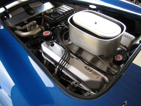 1968 Ford Mustang - The engine bay features prominent 427 Cobra valve covers, indicating a powerful V8 engine.