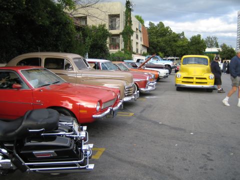 1968 Ford Mustang - A row of vintage vehicles, including a red Pinto and a yellow pickup, are parked in an outdoor lot.