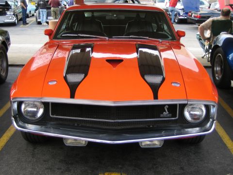 1968 Ford Mustang - Front view of a 1968 Ford Mustang Shelby GT500 with distinctive black racing stripes.