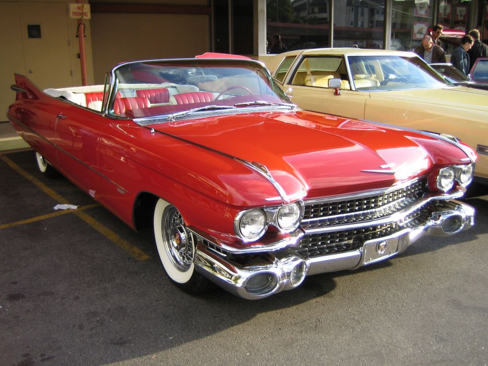 Red 1959 Cadillac convertible front view with white interior