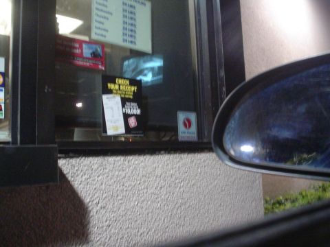 1993 Ford Taurus - A sign inside a drive-thru window advertises a chance to win $10,000 by checking your receipt.