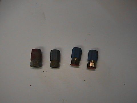 1989 Ford Bronco - Four Schrader valve caps are shown on a white surface.