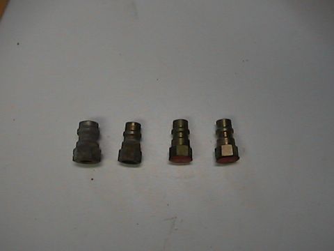 1989 Ford Bronco - Four pneumatic quick connect fittings are shown on a light gray surface.