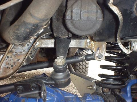 1988 Ford Bronco - Underside view of a vehicle's suspension system, focusing on steering and spring components.