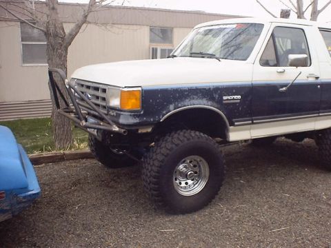 1988 Ford Bronco - This Ford Bronco has a custom front bumper and is lifted with off-road tires.