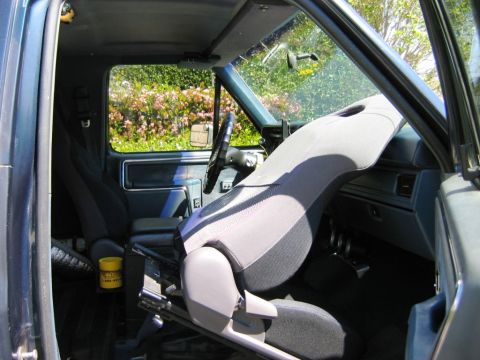 1985 Ford Bronco - Interior view of a pickup truck, focusing on the driver's seat and dashboard area.