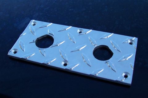 1994 Ford F-150 - Metal part with diamond plate texture and two holes, likely for mounting.