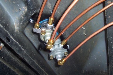 1994 Ford F-150 - Close-up of an air suspension valve manifold with multiple copper lines connected.