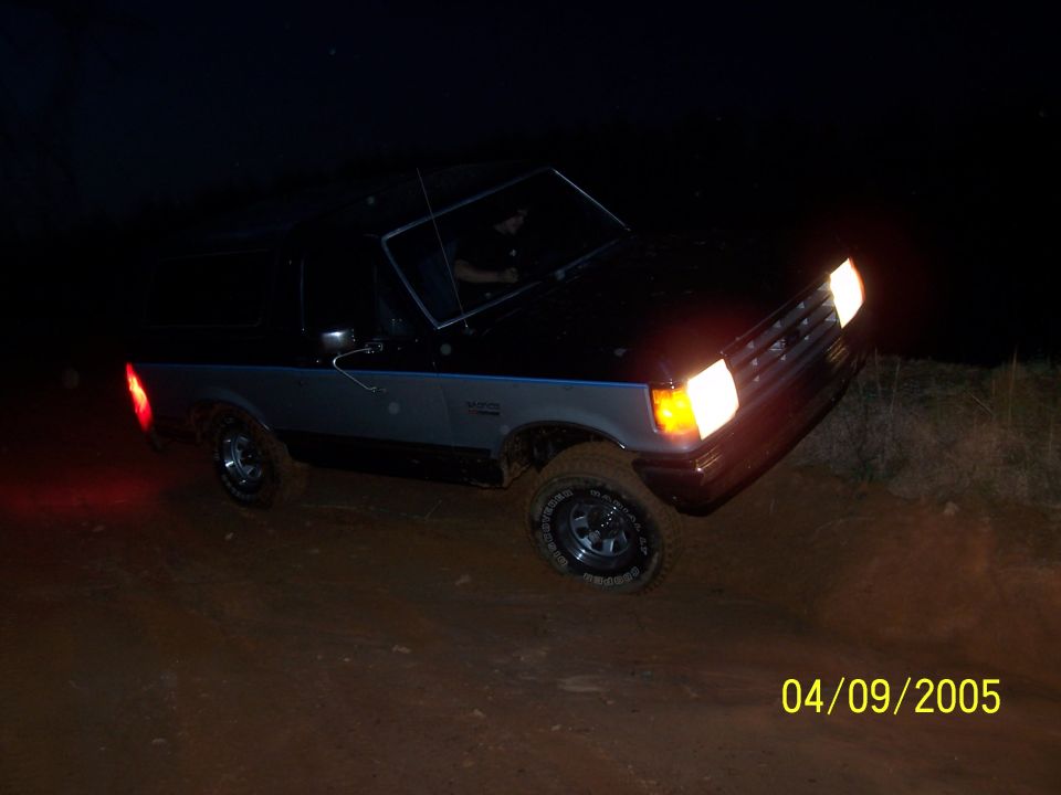 1979 Ford F-150 driving off-road at night, 3q-front view