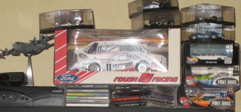 1968 Ford Mustang - Model car in its original packaging, displayed with other collectibles on shelves.
