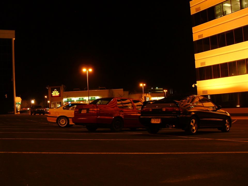 1994 Volkswagen Jetta, red sedan, parked at night
