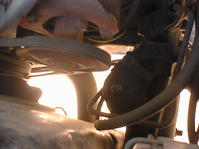 Here is how close the power steering is to the steering box. I have a custom bracket that moves the power steering pump closer to the water pump and in front of the head which is something of a problem for hoses but it gives me a full inch of clearance when using a small diameter pulley.