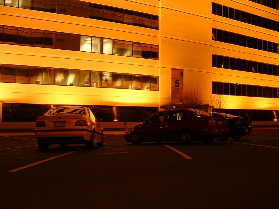 Yellow sedan rear view, license plate visible