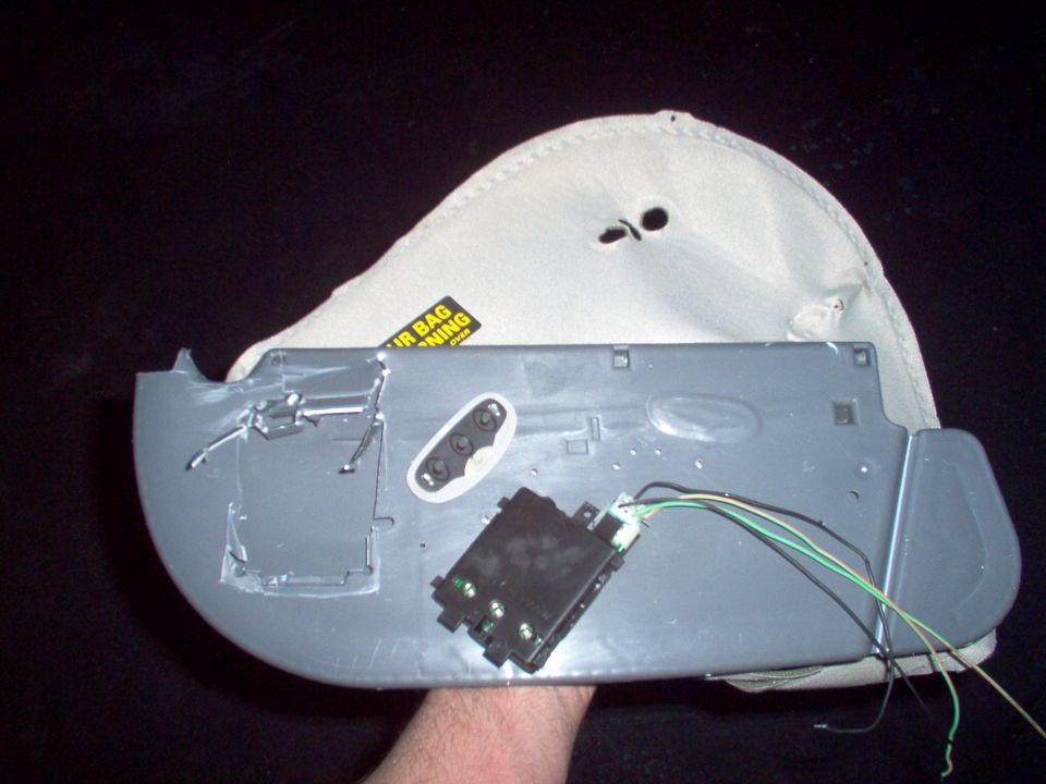 This visor came from an '02 LTC, but it won't fit my '94 CV, so I'm pulling the HomeLink out of it to mount somewhere in my car.  It took some cutting to release the module from the visor shell.