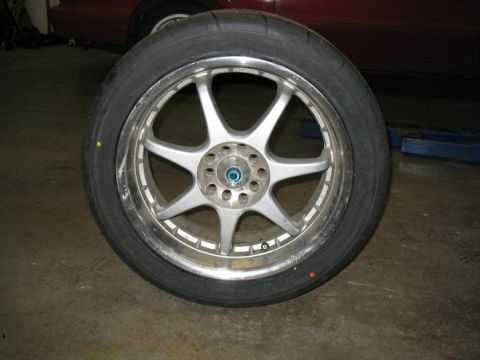 1993 Ford Probe - A close-up of a silver 5-spoke wheel and tire, with the Supermotors.net logo in the lower right corner.