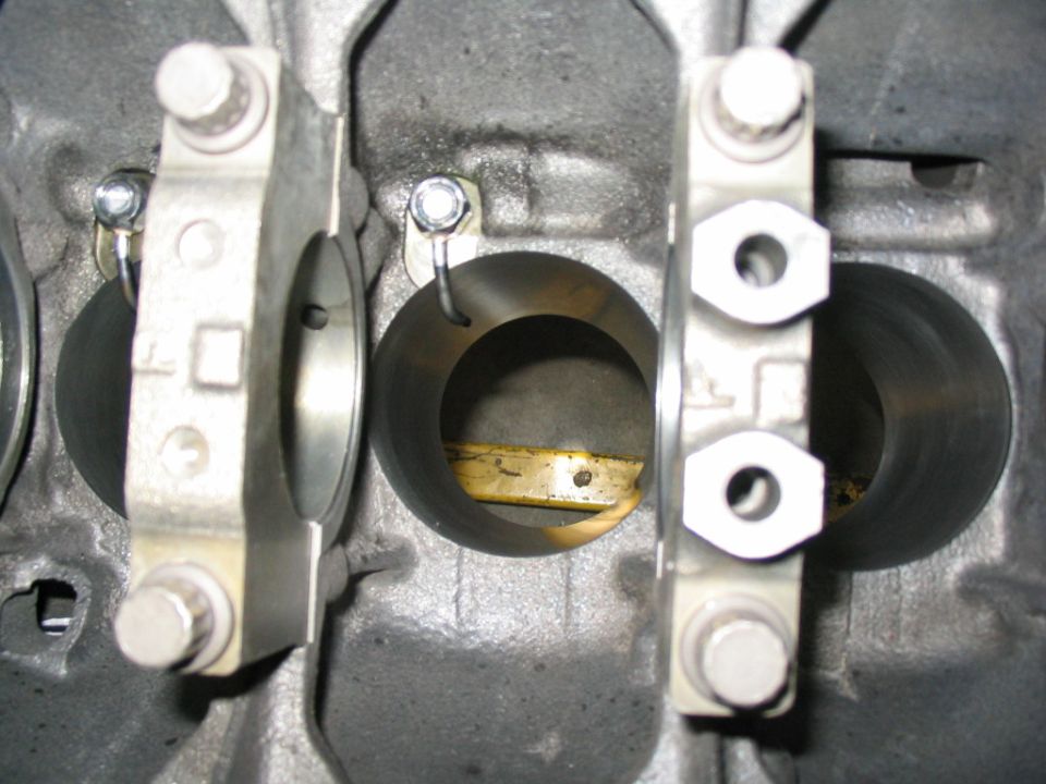 Close-up of engine block showing connecting rod caps and cylinder bores