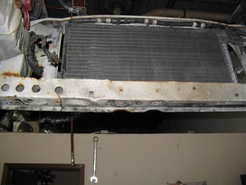 1993 Ford Probe - Radiator and front support structure of a vehicle, showing signs of wear and rust.