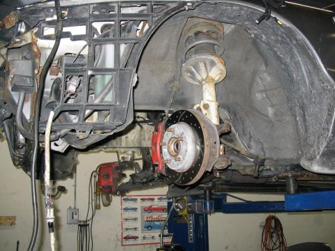 1993 Ford Probe - Close-up view of the front wheel well and suspension system, including the brake assembly.