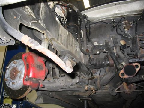 1993 Ford Probe - Underside view of a vehicle's front suspension and steering system components.