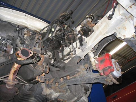 1993 Ford Probe - Underside view of a car's engine and front suspension system, showing various mechanical parts.
