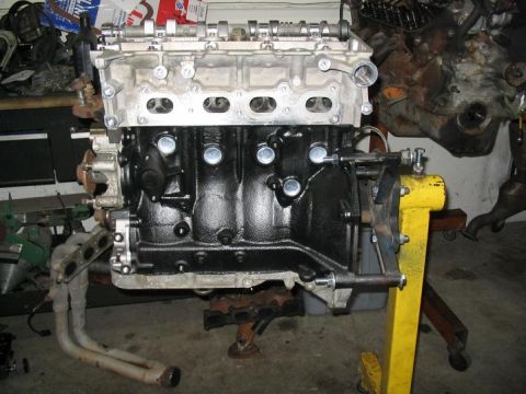 1993 Ford Probe - Engine assembly on a stand, showing the block, cylinder head, and exhaust manifold.