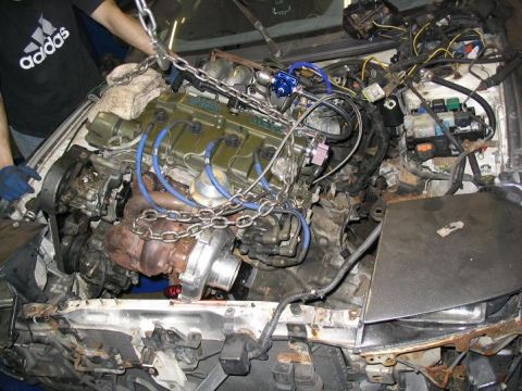 1993 Ford Probe - Engine removal in progress, with chains supporting the powerplant.
