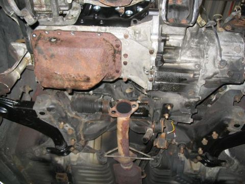 1993 Ford Probe - Underside view of a vehicle's engine and transmission, showing the oil pan and exhaust components.