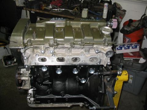1993 Ford Probe - Engine components are visible in this workshop photo, with the valve cover painted a metallic olive green.