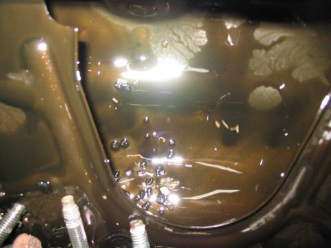 1993 Ford Probe - Engine oil appears contaminated with debris and metal particles.