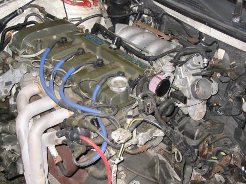 1993 Ford Probe - Close-up view of a car's engine bay, showing various components and wiring.