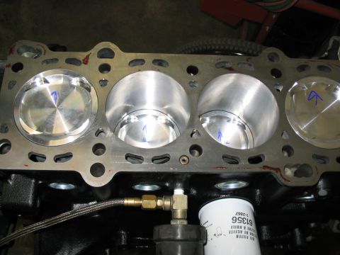 1993 Ford Probe - Close-up view of an engine block's cylinders and pistons, with an oil filter and plumbing visible.