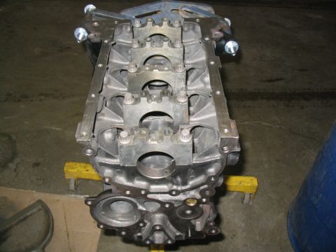 1993 Ford Probe - Engine block assembly shown on a yellow stand in a workshop setting.