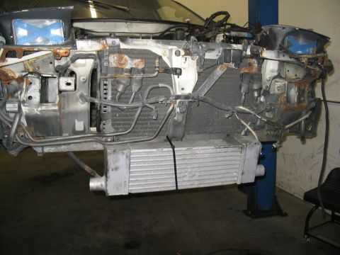 1993 Ford Probe - The front end of a car is disassembled, revealing the radiator and an intercooler.
