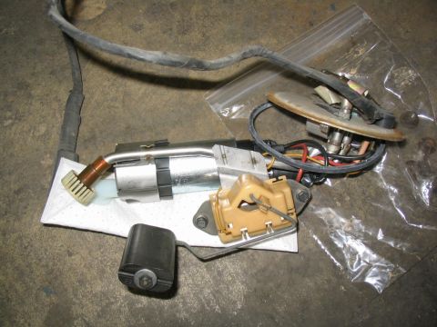 1993 Ford Probe - A disassembled fuel pump assembly lies on a concrete surface next to a plastic bag.