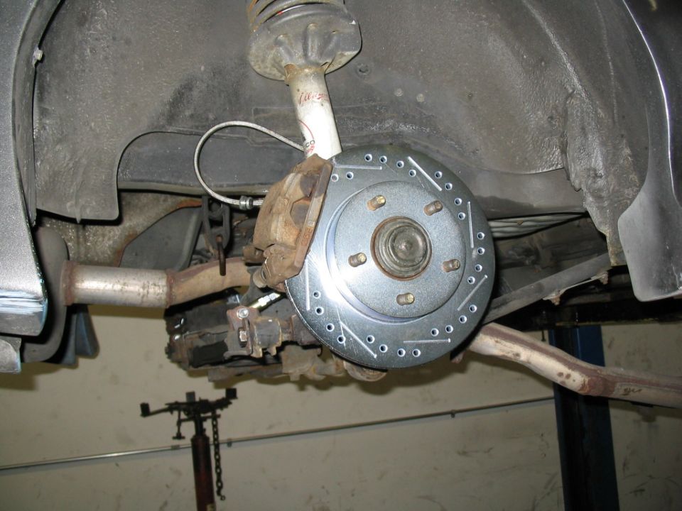 Rear brake rotor and caliper with new drilled rotor
