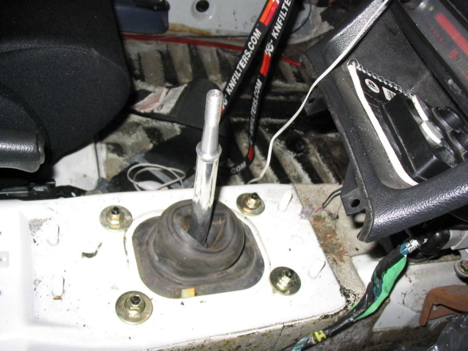 car's gear shifter and surrounding interior components, with K&N Filters branding visible on a strap
