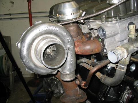 1993 Ford Probe - Close-up of a turbocharger and engine components, showing a Garrett turbo and associated plumbing.