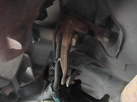 1989 Ford Bronco - Close-up of an underbody suspension part with a visible wiring harness and Supermotors.net watermark.