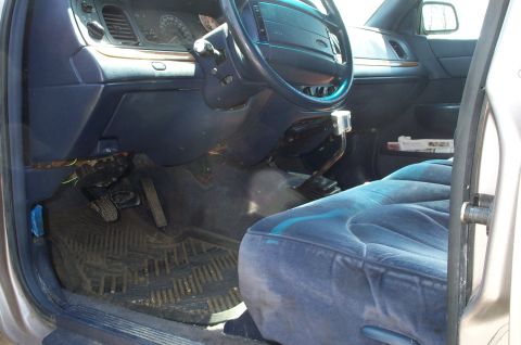 1998 Ford Crown Victoria - Interior view of a 1998 Ford Crown Victoria, highlighting the dashboard and driver's seat.