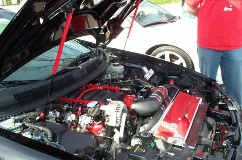 1998 Ford Crown Victoria - Modified engine bay with performance parts, another vehicle visible in the background.