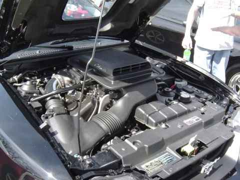 1998 Ford Crown Victoria - Close-up of a car's engine bay, showing various components and some text.