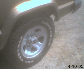 1988 Jeep Cherokee - Close-up of the rear wheel and fender of a 1988 Jeep Cherokee.