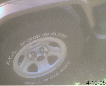 1988 Jeep Cherokee - A close-up view of a tire on a Jeep Cherokee, showing the brand and model details on the sidewall.