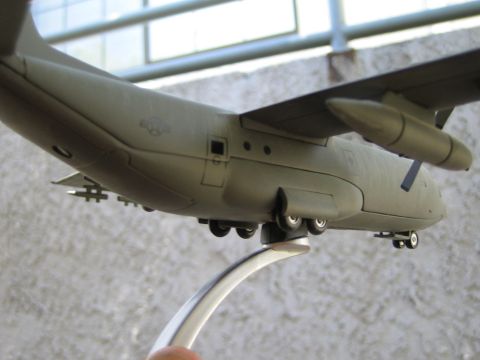 1968 Ford Mustang - A detailed model airplane, depicted from its side, is mounted on a silver display stand.