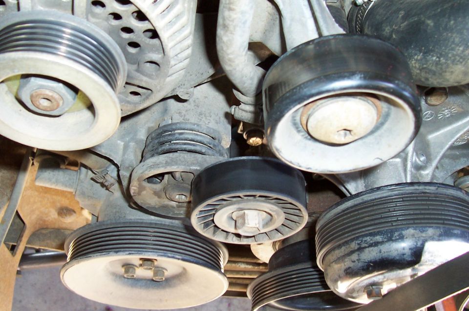 Engine front accessory pulleys and belt tensioner with the serpentine belt removed